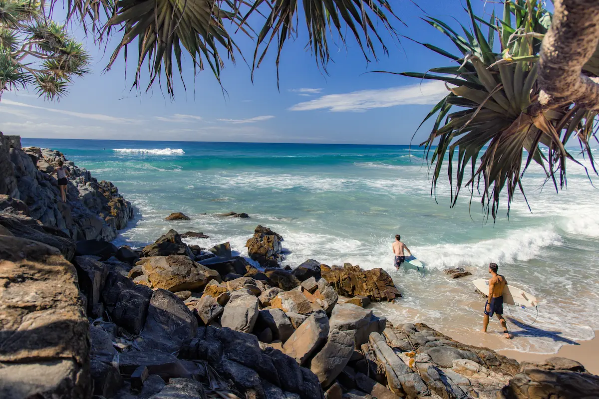 Surfers entering the water at Sunshine Beach